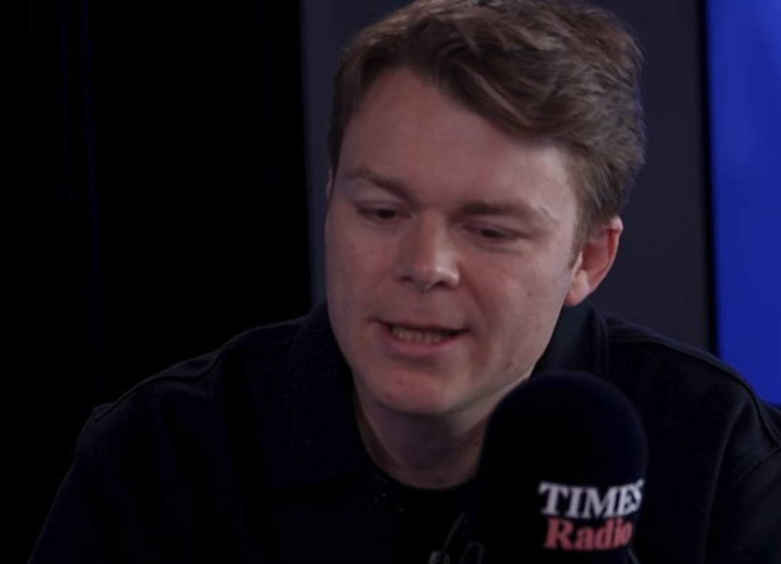 Louis Mosley, CEO of Palantir UK, speaking into a Times Radio microphone during a studio interview.