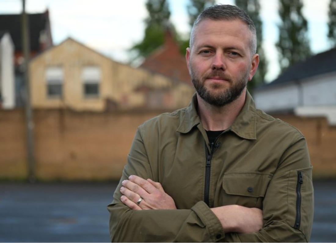 Robert Kenyon, Reform UK’s candidate for the Makerfield by-election, standing outdoors with his arms folded during a campaign-style portrait photograph.