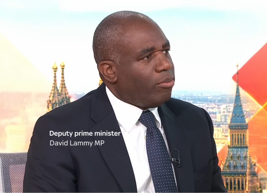 Deputy Prime Minister David Lammy MP speaking during a televised political interview while wearing a dark suit and tie.