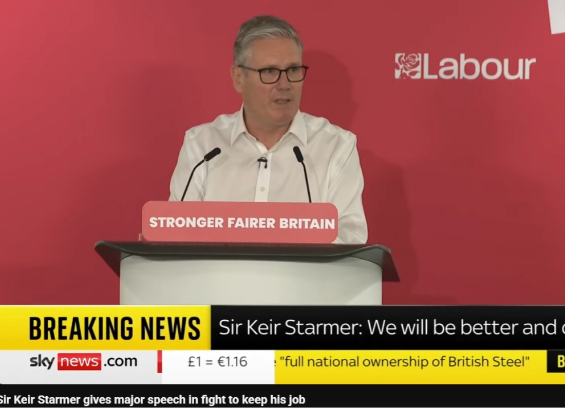 Prime Minister Keir Starmer delivers a speech at a Labour Party podium during a live Sky News broadcast.