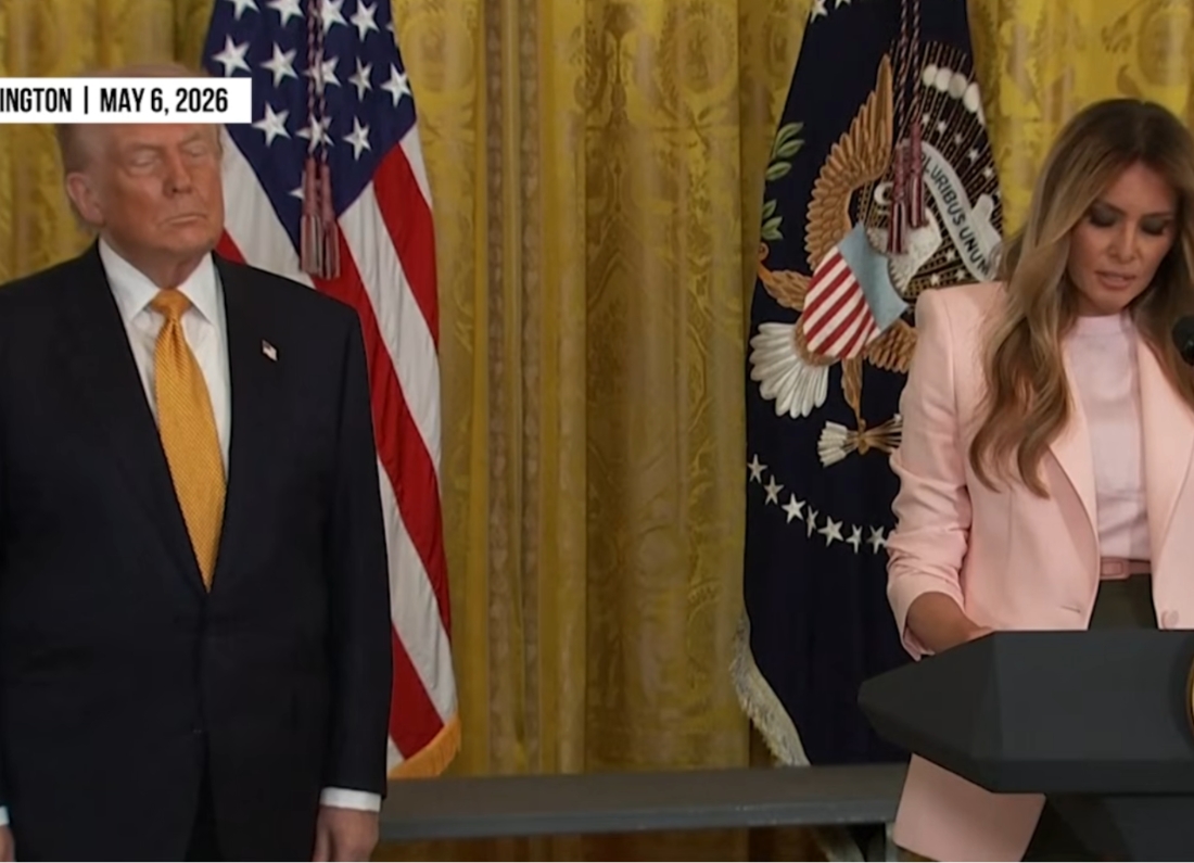 Melania Trump speaks at a White House event while Donald Trump stands beside her.