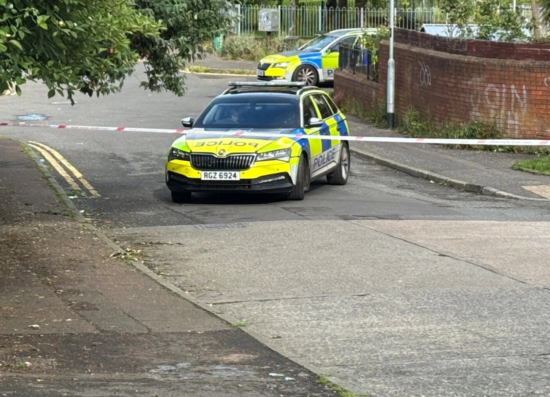 Police vehicles block off a street in Belfast as officers investigate a serious stabbing incident.