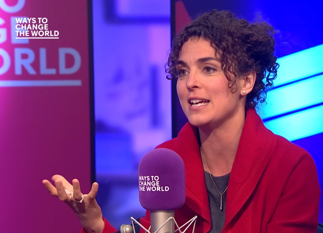 Economist Clara Mattei speaking into a microphone during a Ways to Change the World interview.