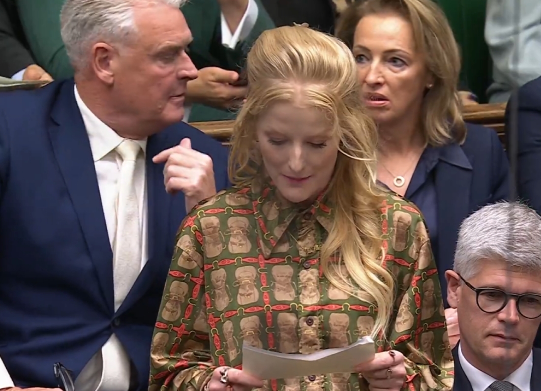 Green Party MP Hannah Spencer speaks during Prime Minister’s Questions in the House of Commons, while Reform UK MPs Lee Anderson and Sarah Pochin are visible behind her reacting.