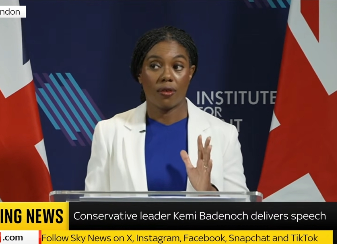 Conservative Party leader Kemi Badenoch delivers a speech from a podium during an event in London.