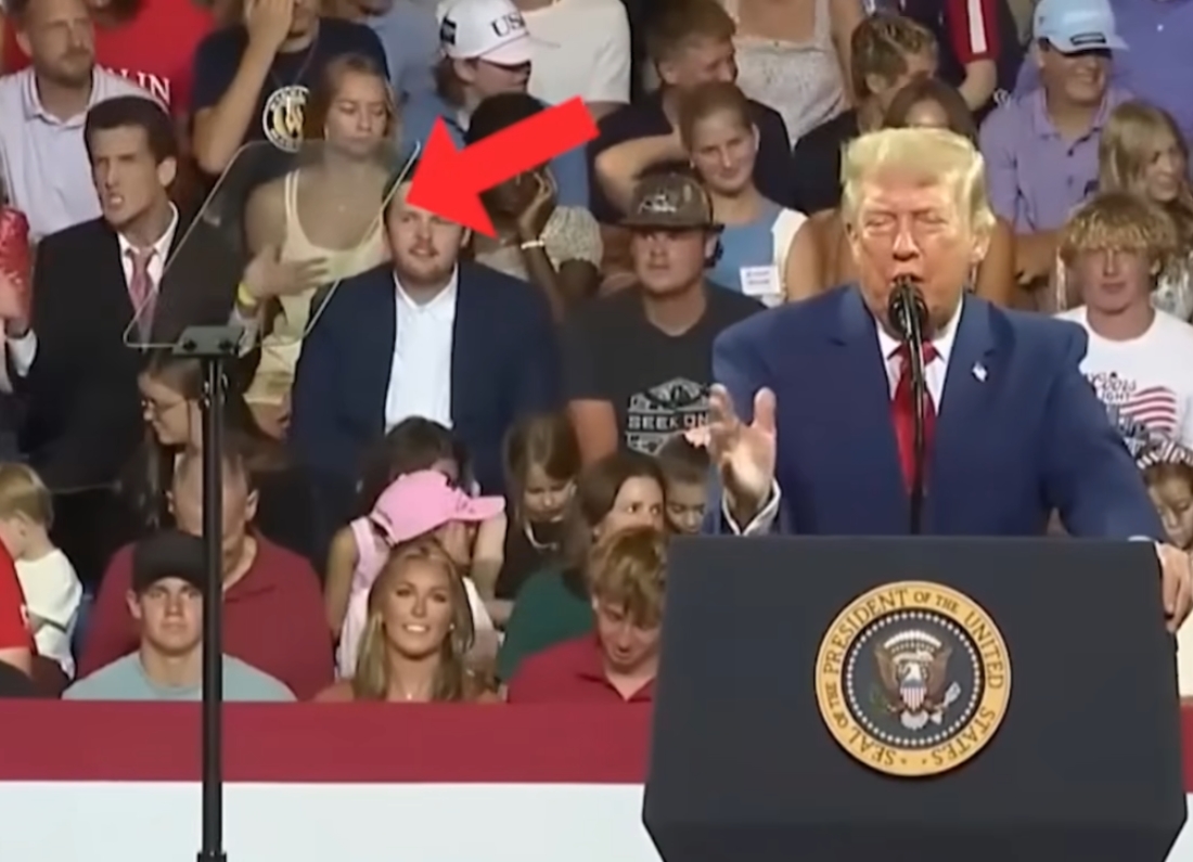 A man sitting behind Donald Trump copies the president’s hand gestures during a rally at Wheeler High School in Marietta, Georgia.