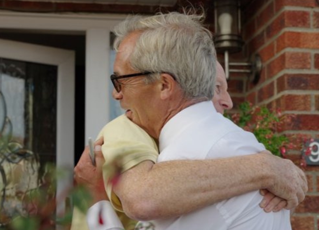 Nigel Farage hugs an elderly voter during a doorstep campaign video in Clacton ahead of the 2026 by-election.