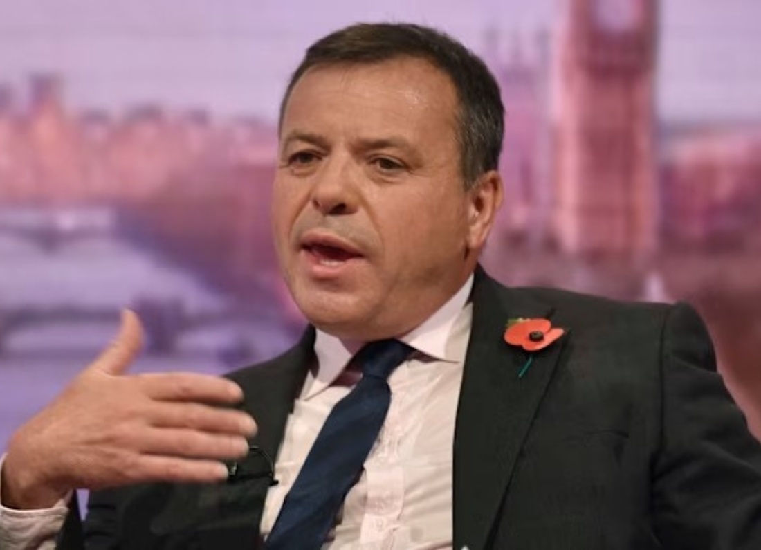 Arron Banks alongside his deleted social media post complaining about non-white workers at Heathrow Airport