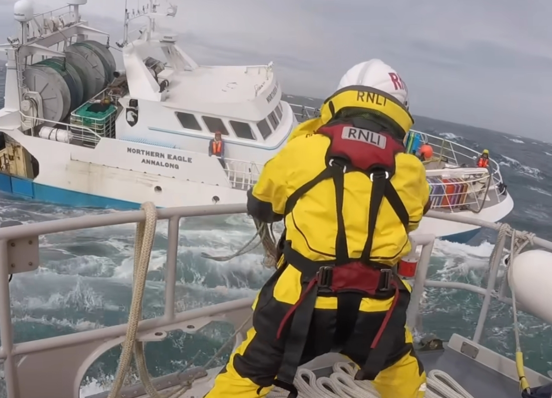 An RNLI lifeboat crew operating at sea as the charity faces criticism over rescues involving people crossing the Channel