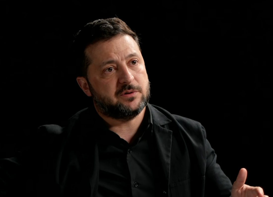 Ukrainian President Volodymyr Zelenskyy gestures while speaking during an interview with DOAC, discussing Russia's war in Ukraine.